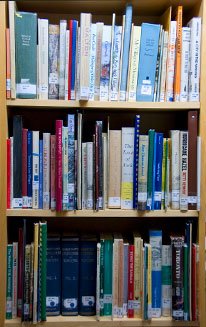 Bookshelves with catalogued volumes on social history, decorative arts, local genealogy, food history, and local heritage.